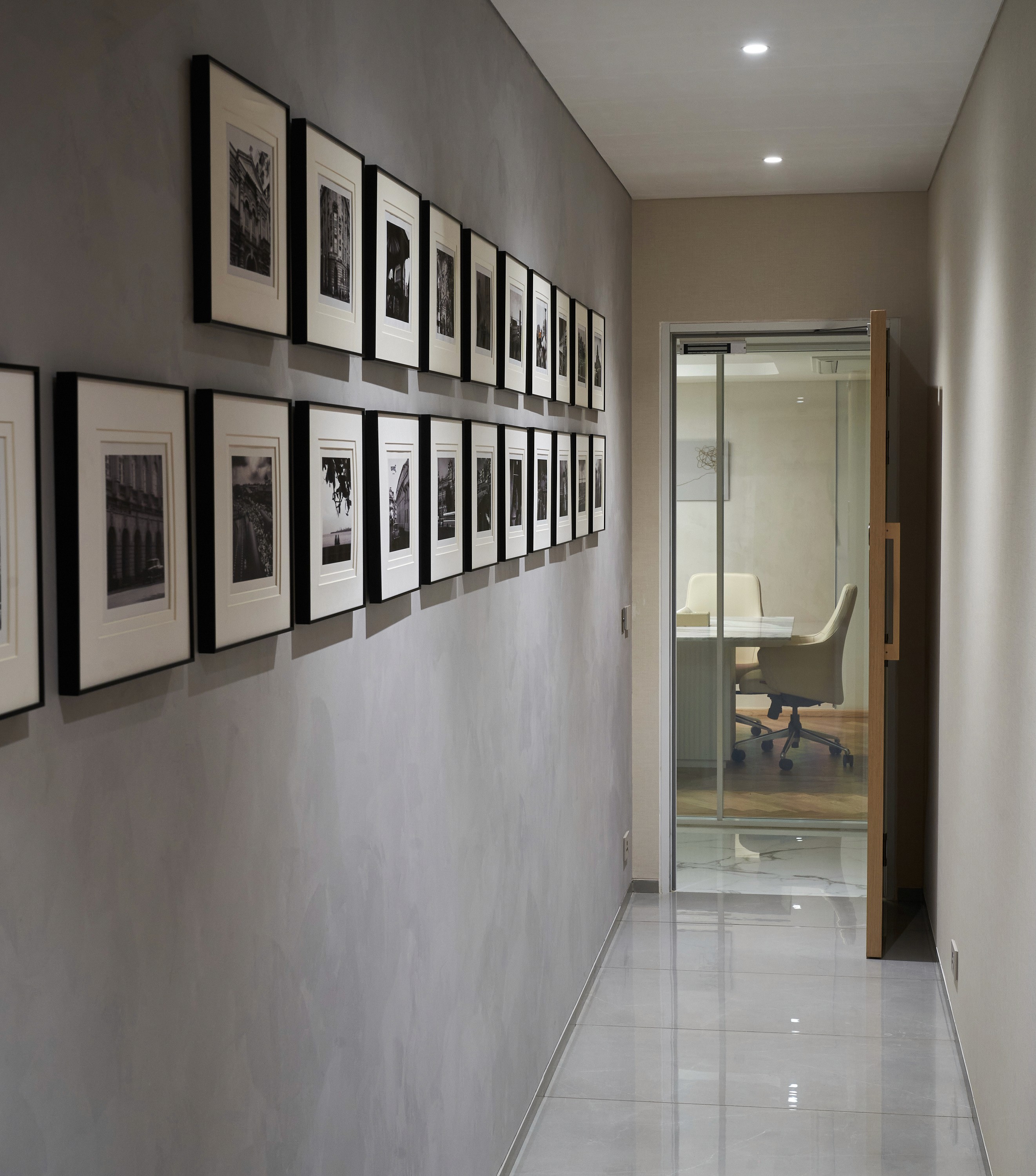 Corridor with black and white wall frames