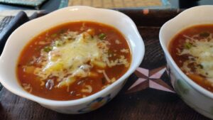 Bowls filled with vegetable stew and topped with cheese