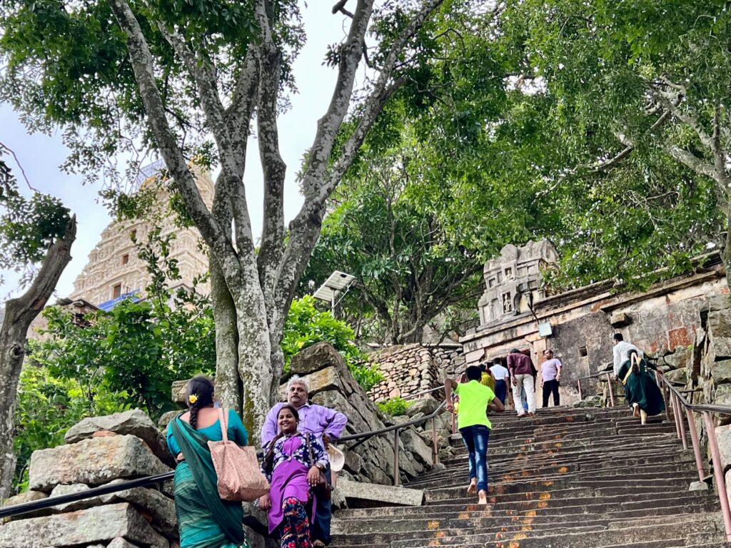 The steps leading to the Yoga Narasimha Temple at Melukote. People are stopping to take rest and click pictures.