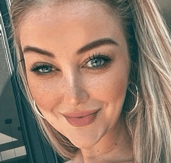 man in white button up shirt and black vest