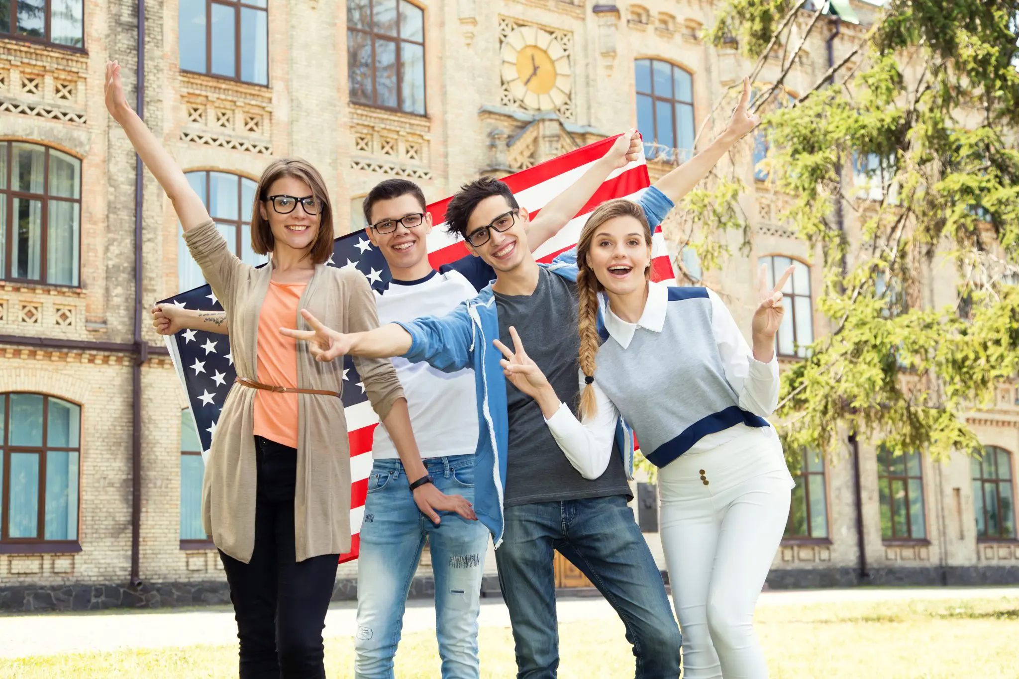 Students posing in front of an American flag