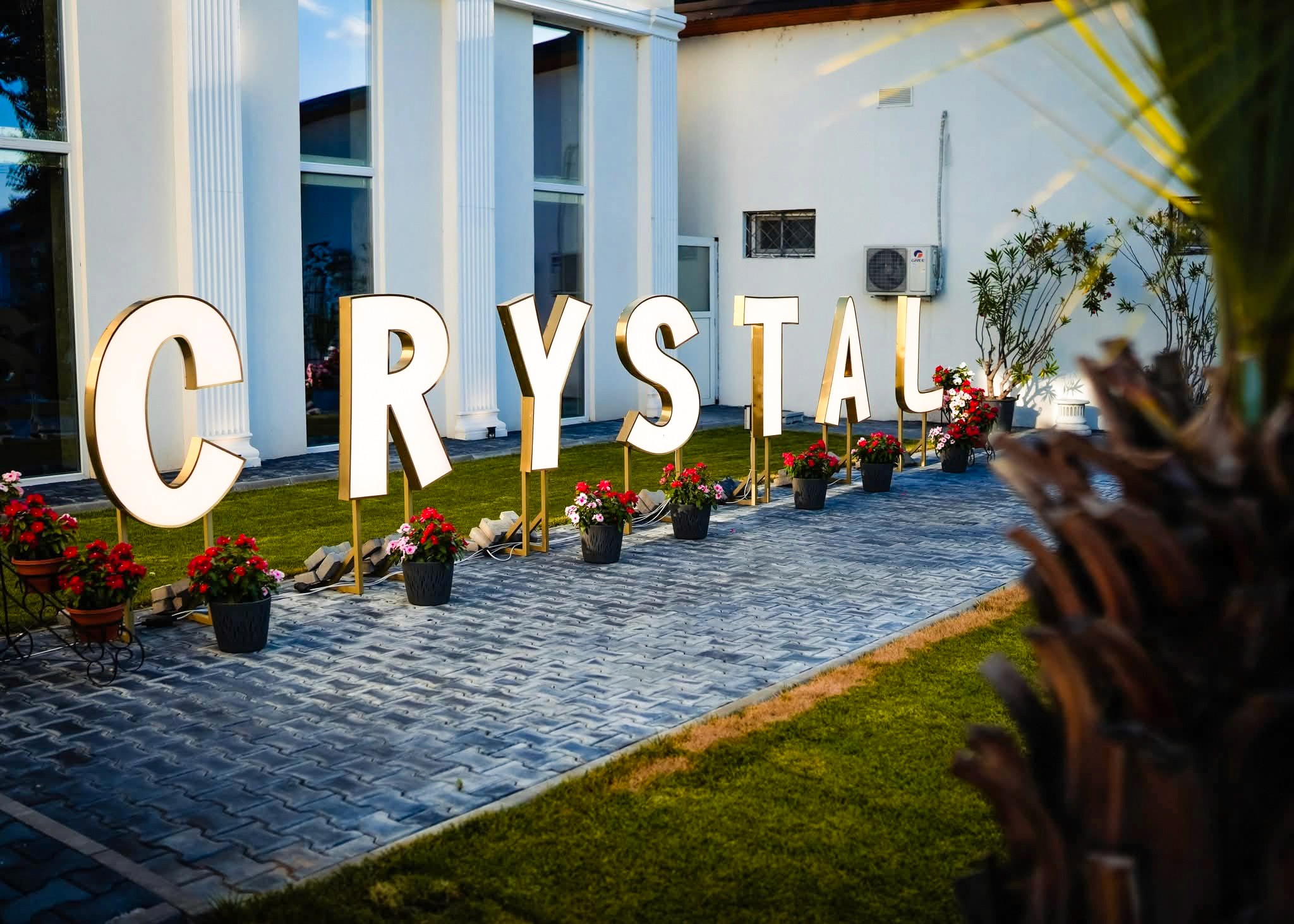 Modern living room with vertical garden, yellow sofas, and stylish coffee tables.