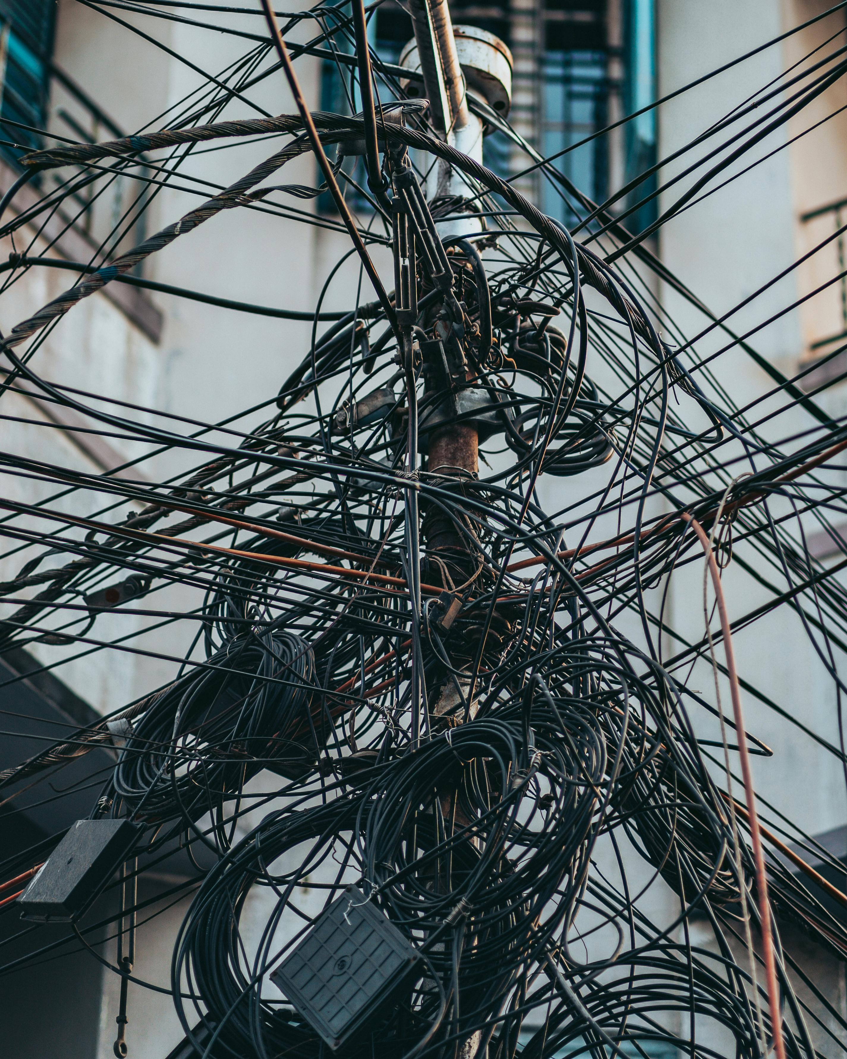 chaotic-tangle-of-electricity-wires-on-an-urban-street-utility-pole,-showcasing- - rupinder-singh (pexels)