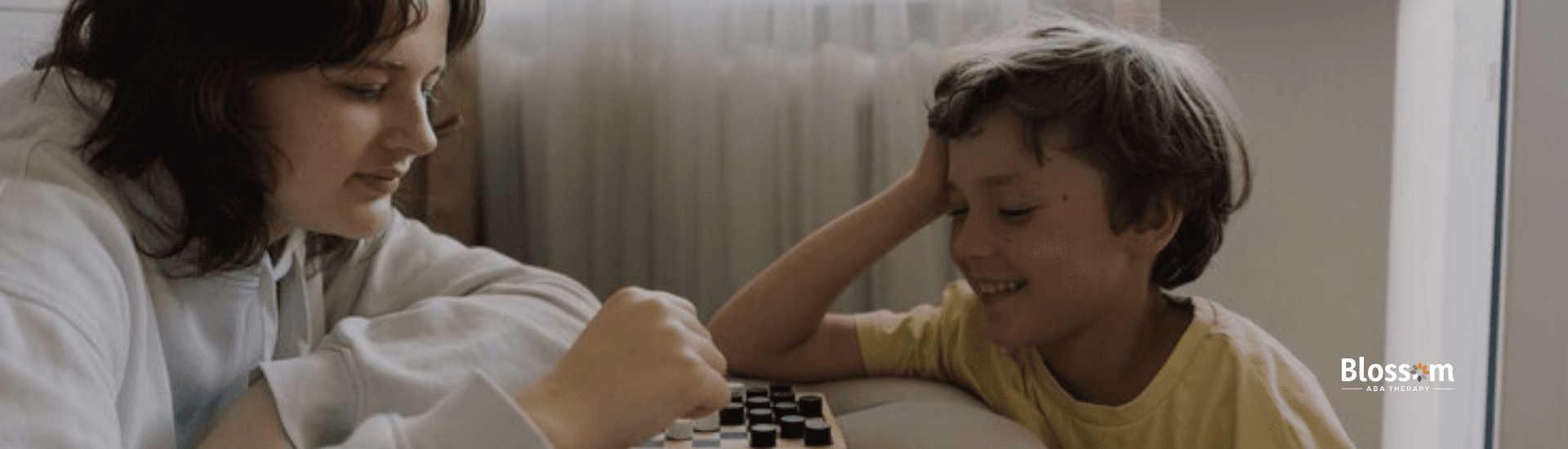 A child diagnosed with mild autism and his RBT playing a board game