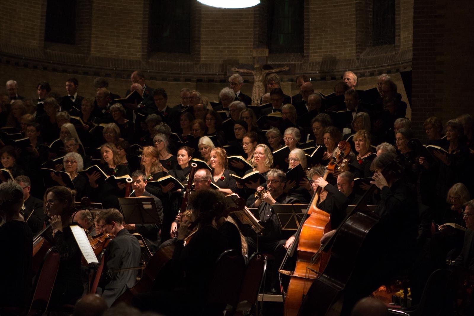 people sitting on brown wooden bench inside building