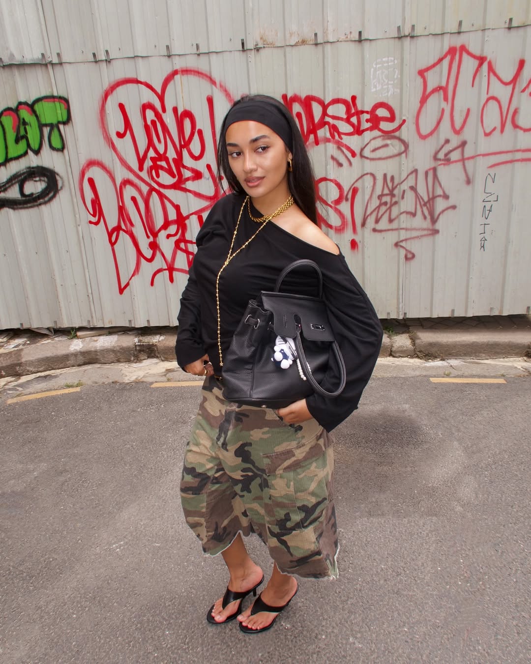 woman who is posing in front of graff