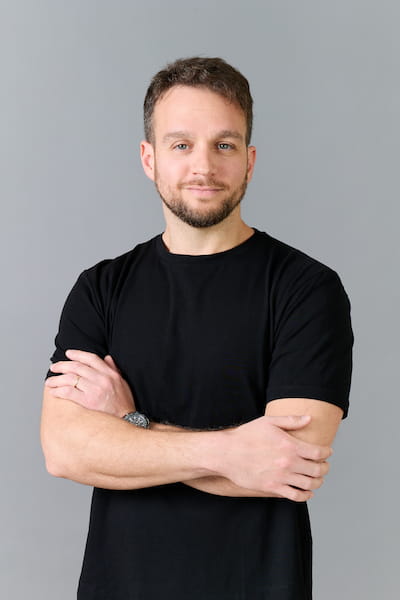 man in gray polo shirt smiling