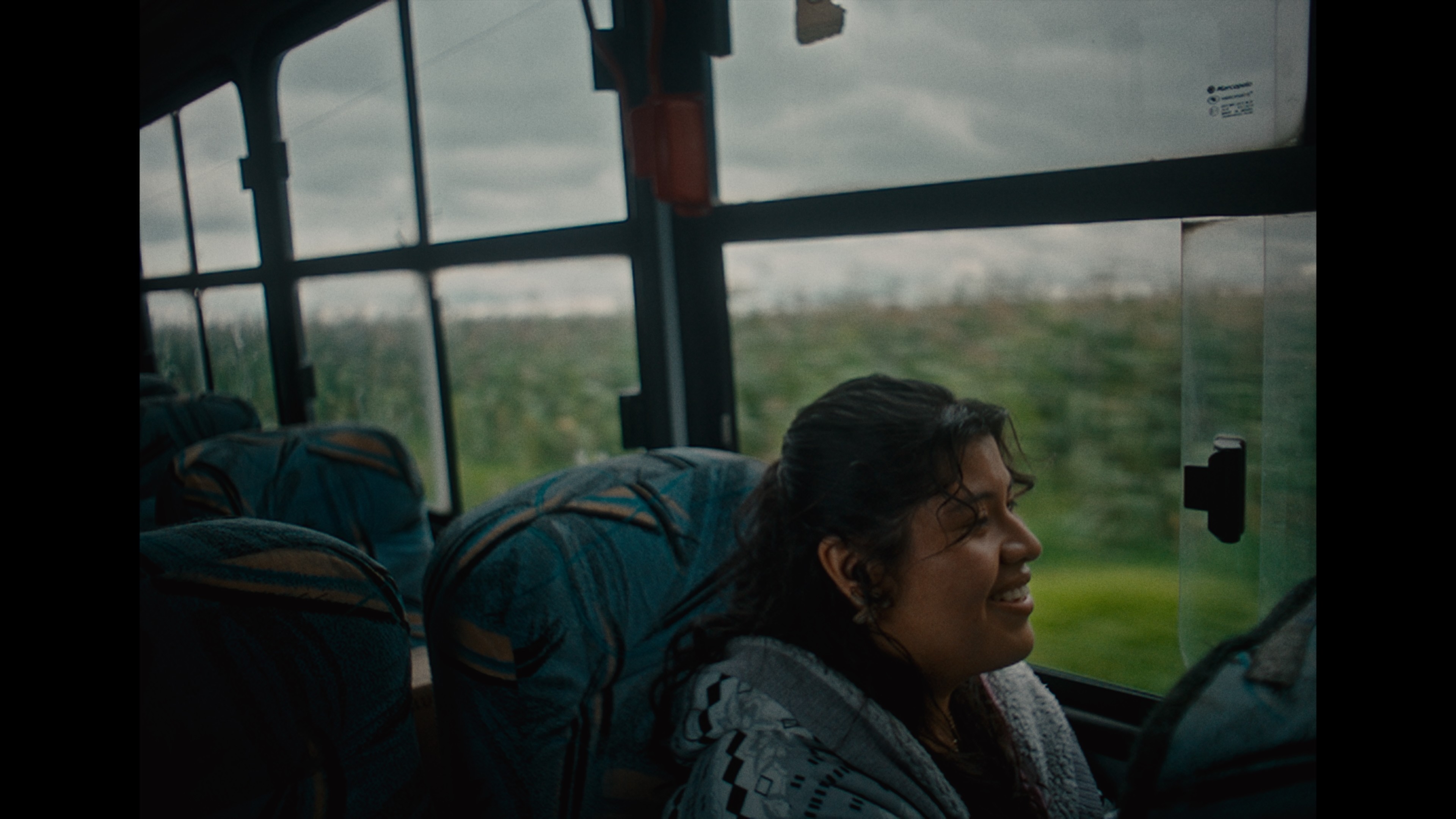 Woman in a light suit sitting thoughtfully against a terracotta wall