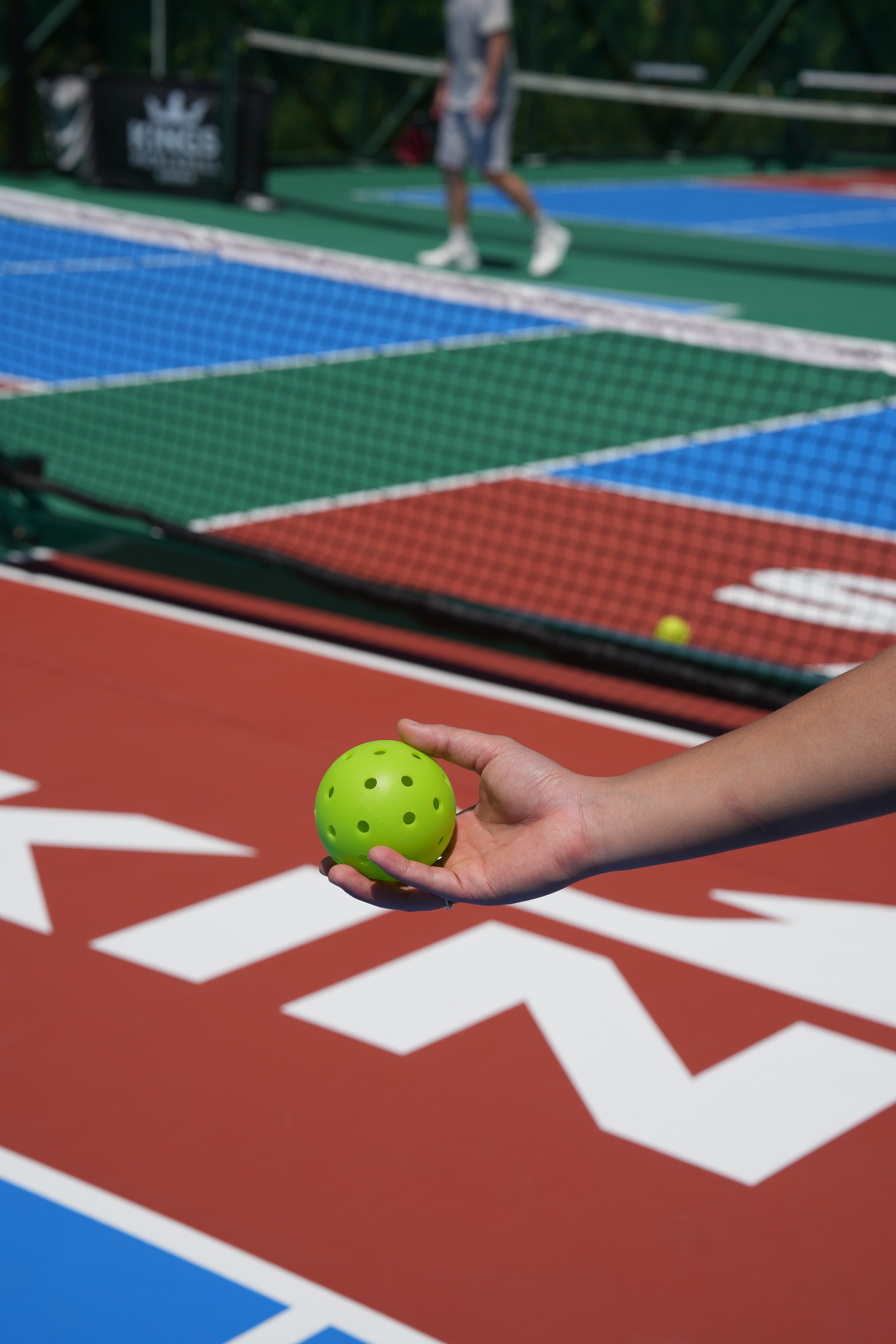 Female tennis player holding a racket and ball