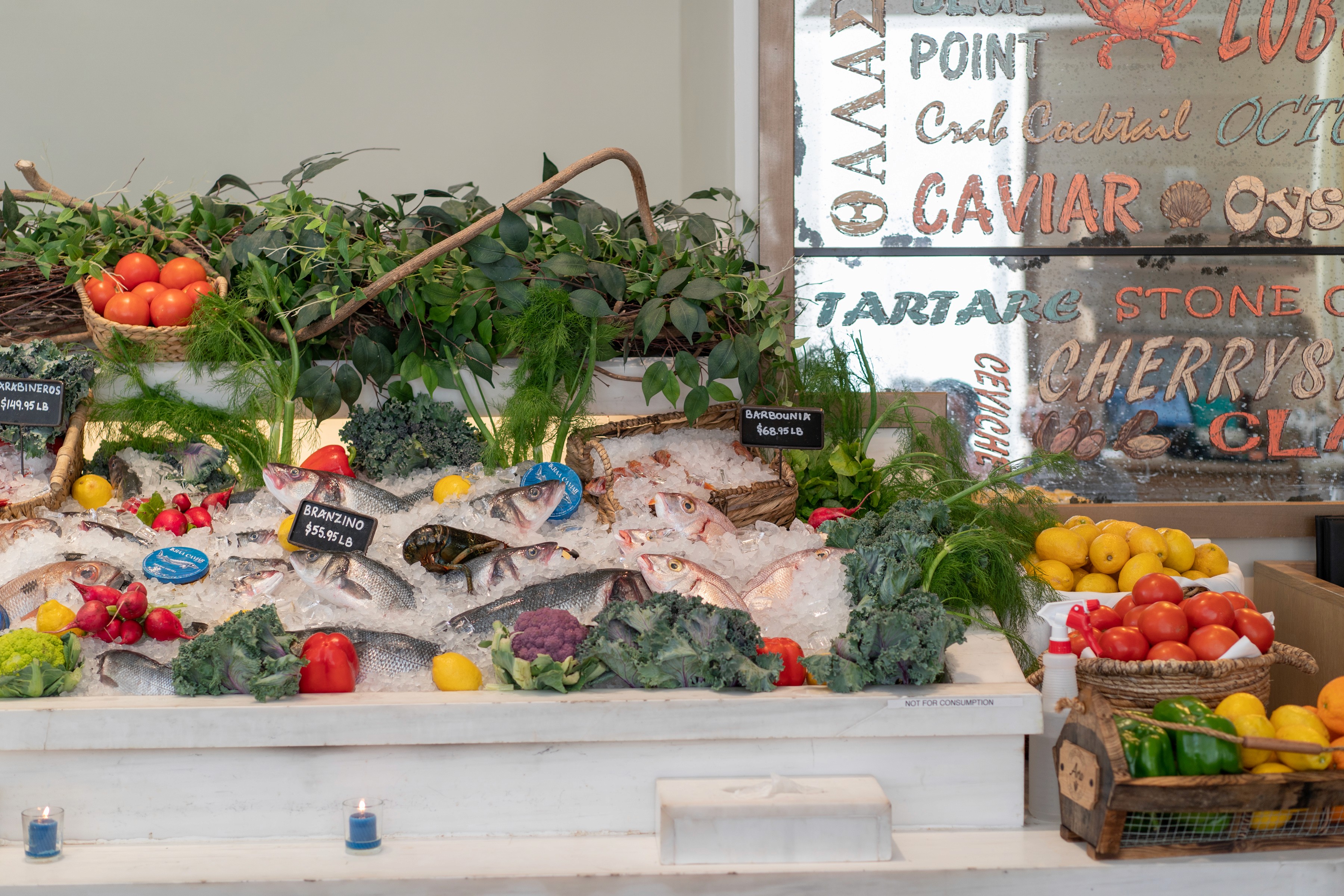 A vibrant display of fresh fruits and vegetables arranged on a market stall, showcasing a variety of colors and textures.