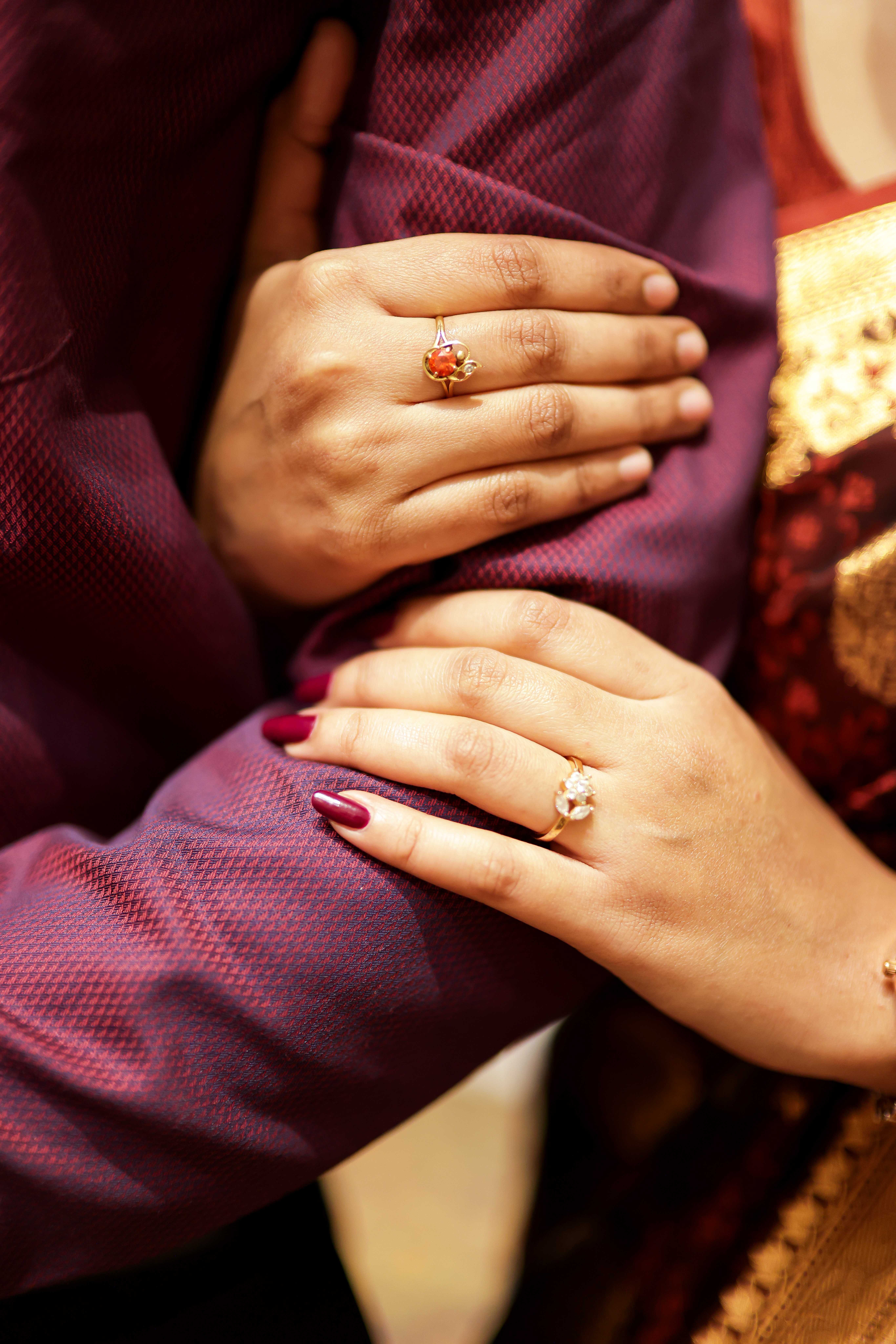 A bride and groom share a kiss, enveloped in the bride's flowing veil. The soft focus and gentle light convey a romantic, intimate atmosphere.
