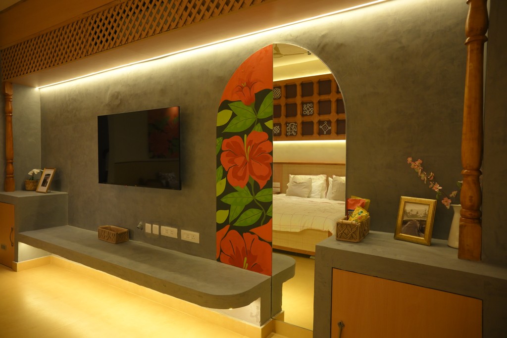 A woman lying on a massage bed, illuminated by soft sunlight streaming through a nearby window. A lush green plant in the background enhances the peaceful and rejuvenating ambiance.