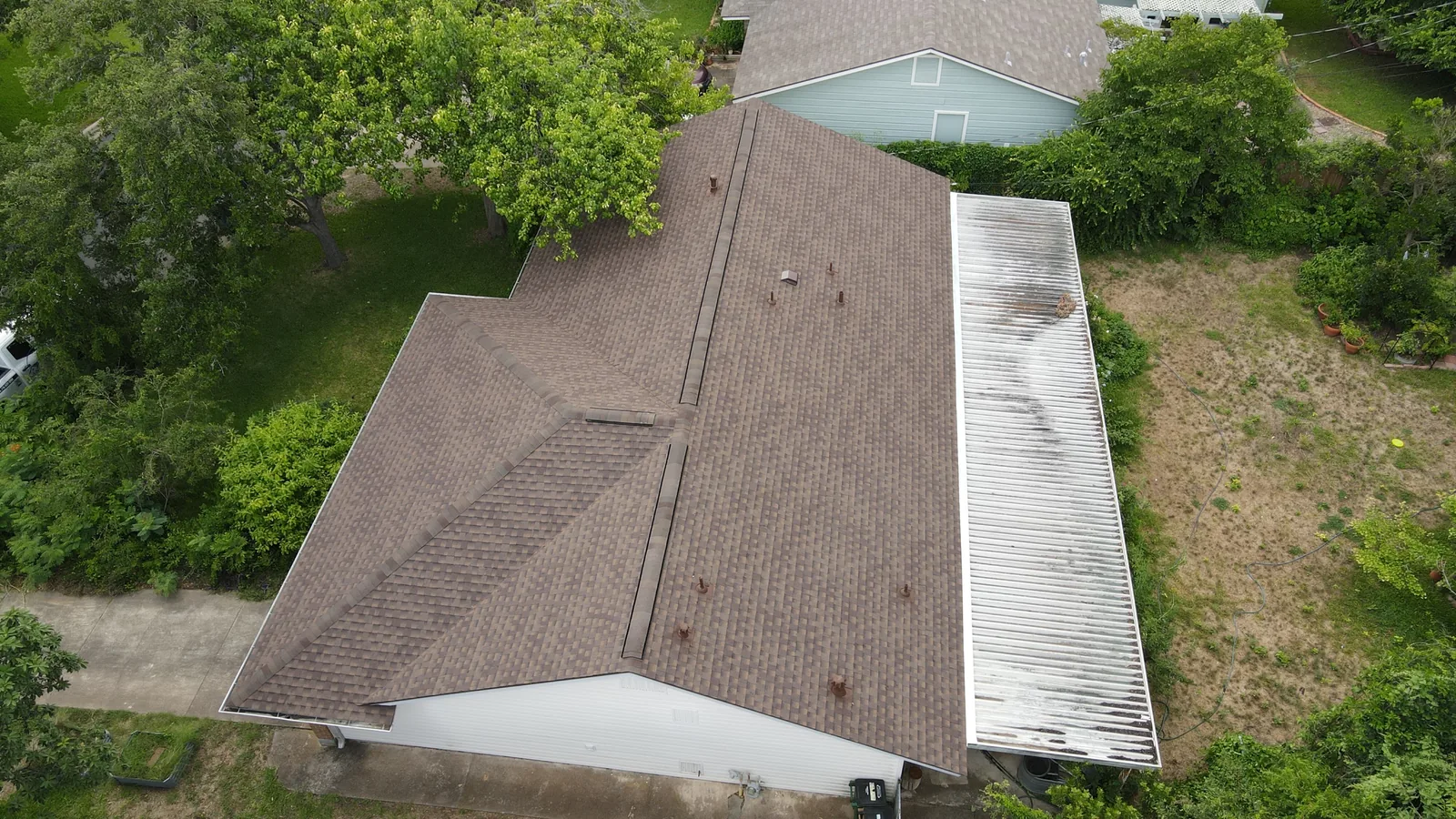After - another angle: new shingles above a covered patio.