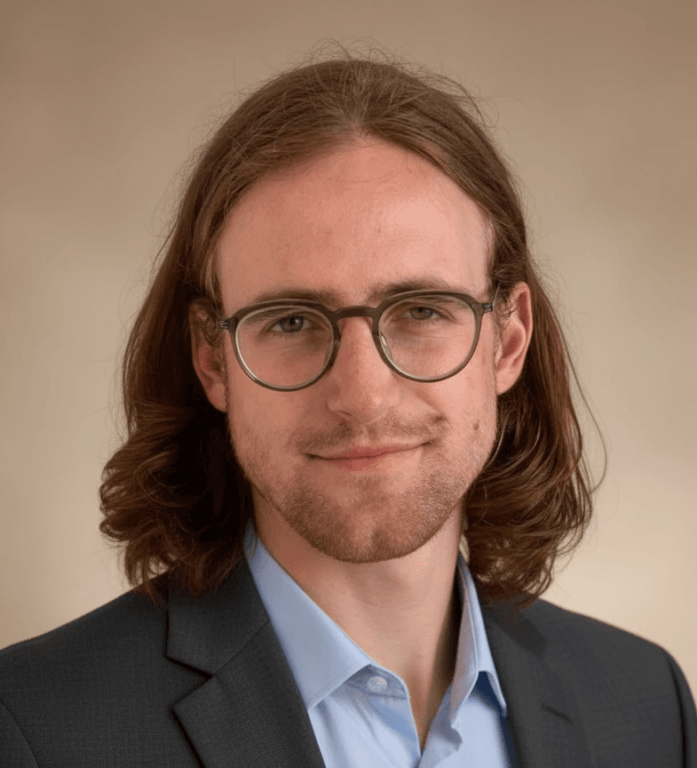 A professional headshot of Dorian Barker, the SaaS copywriter