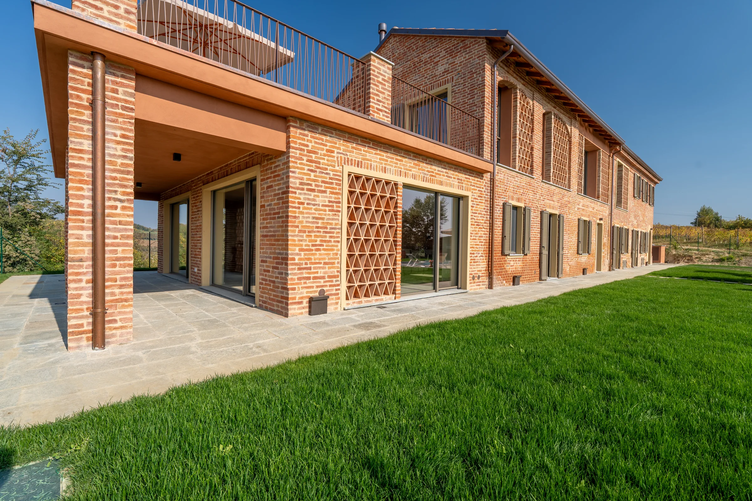 Brick facade and courtyard — Fubine Monferrato, Italy. Photography by Yunes Calore.