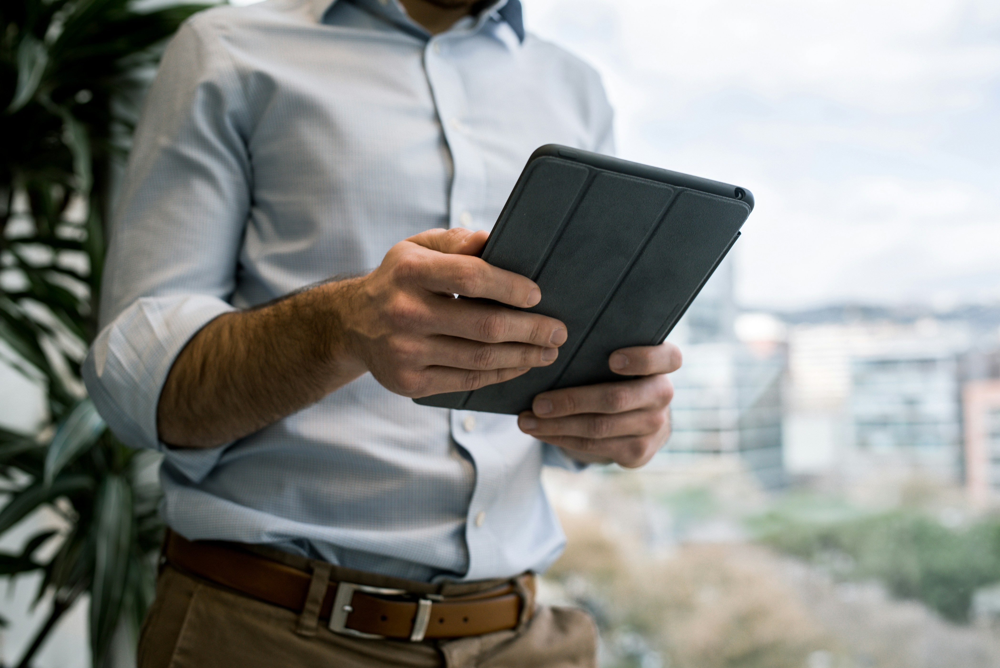 man holding a tablet - How To Take Notes In Medical School