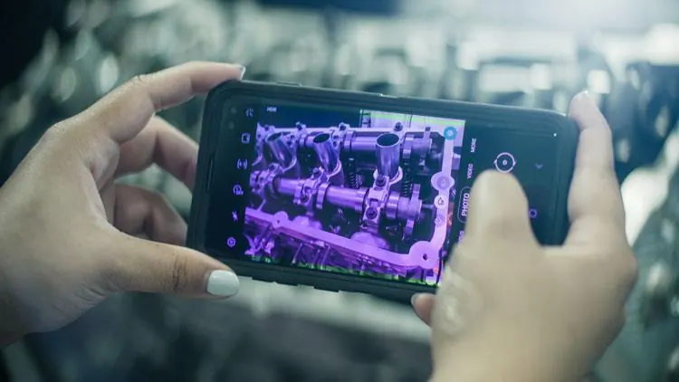 Person holding a phone running MVS software