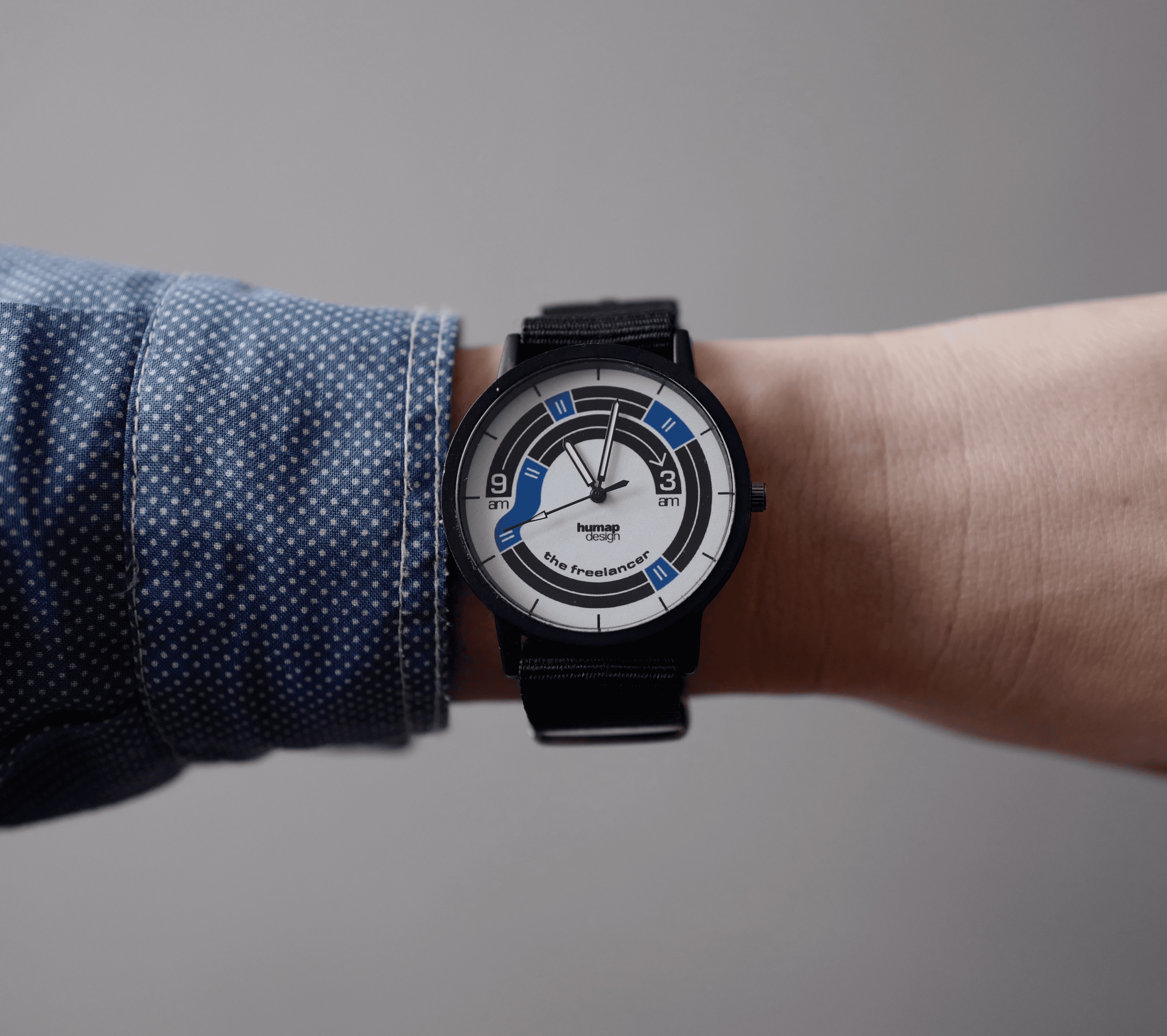 An ironic data-driven wristwatch visualizing freelance work patterns through time tracking