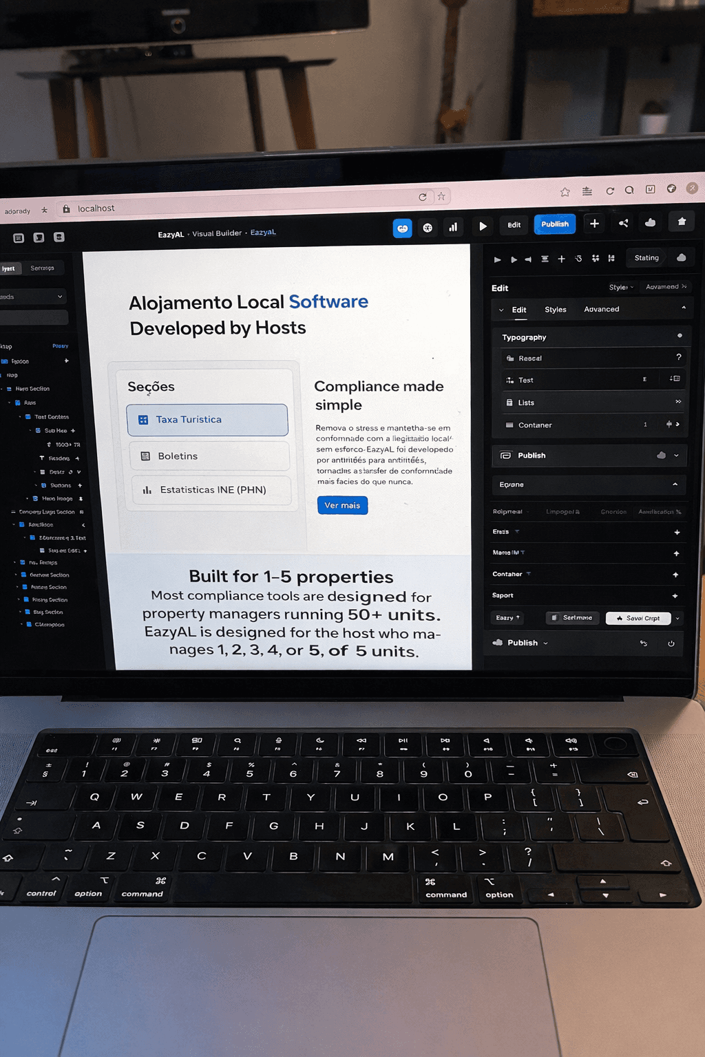 Laptop showing Local Software interface for property management, with keyboard in foreground.