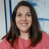 a woman in a pink dress posing for a picture