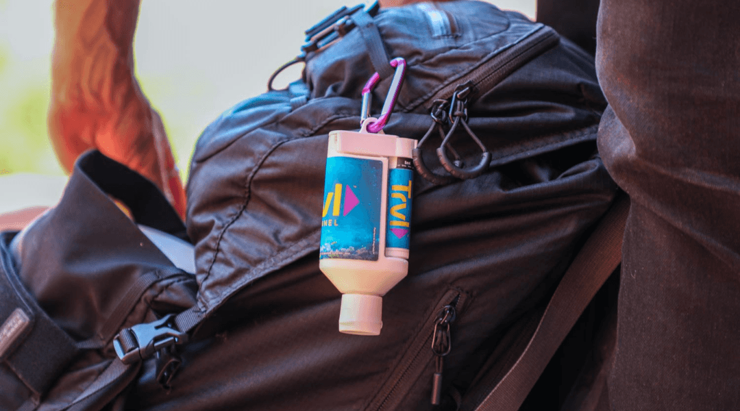 A Sunscreen lip balm duo hanging off of a backpack