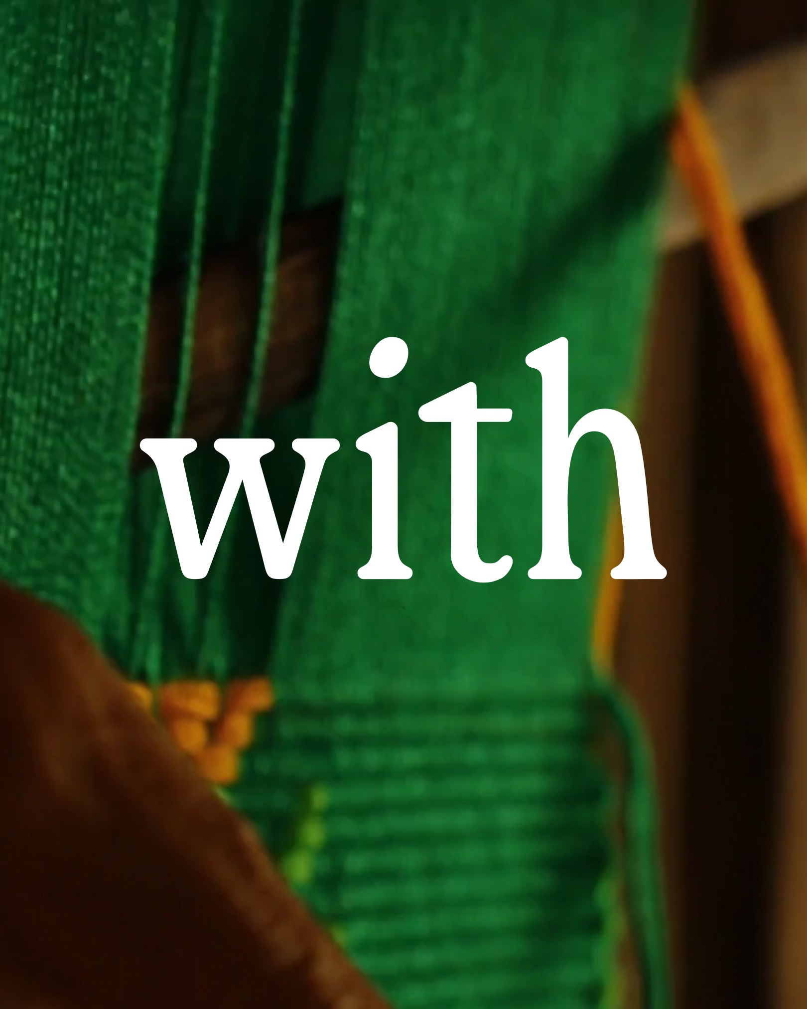 A close-up of green woven threads with the word "with" prominently displayed in white text.