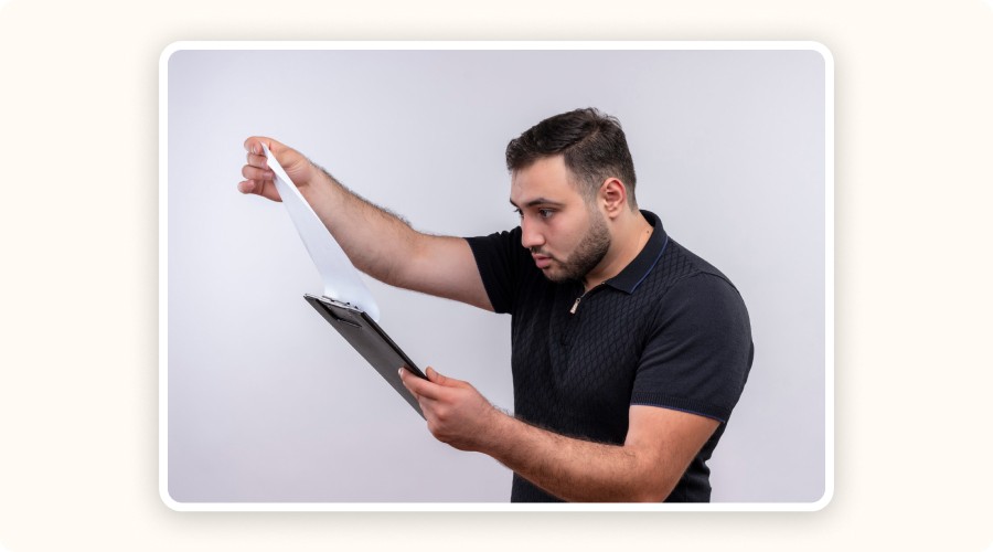 A surprised man discovering unexpected fees on a logistics quote, symbolizing the lack of pricing transparency when choosing an ecommerce fulfillment center.