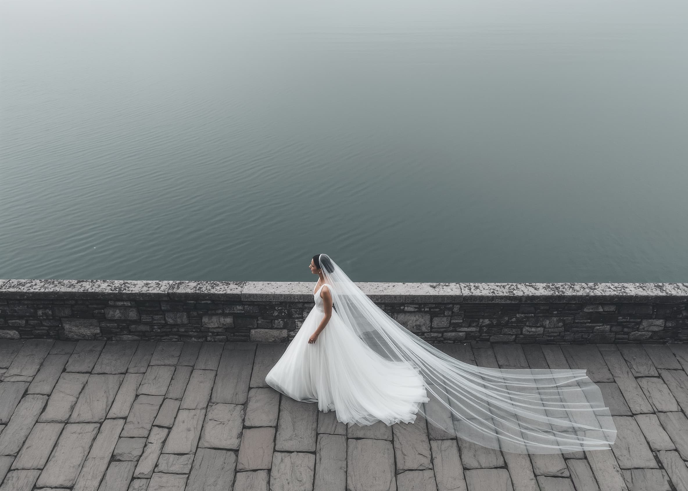 Portrait of wedding photographer – woman laughing outdoors, black and white photo