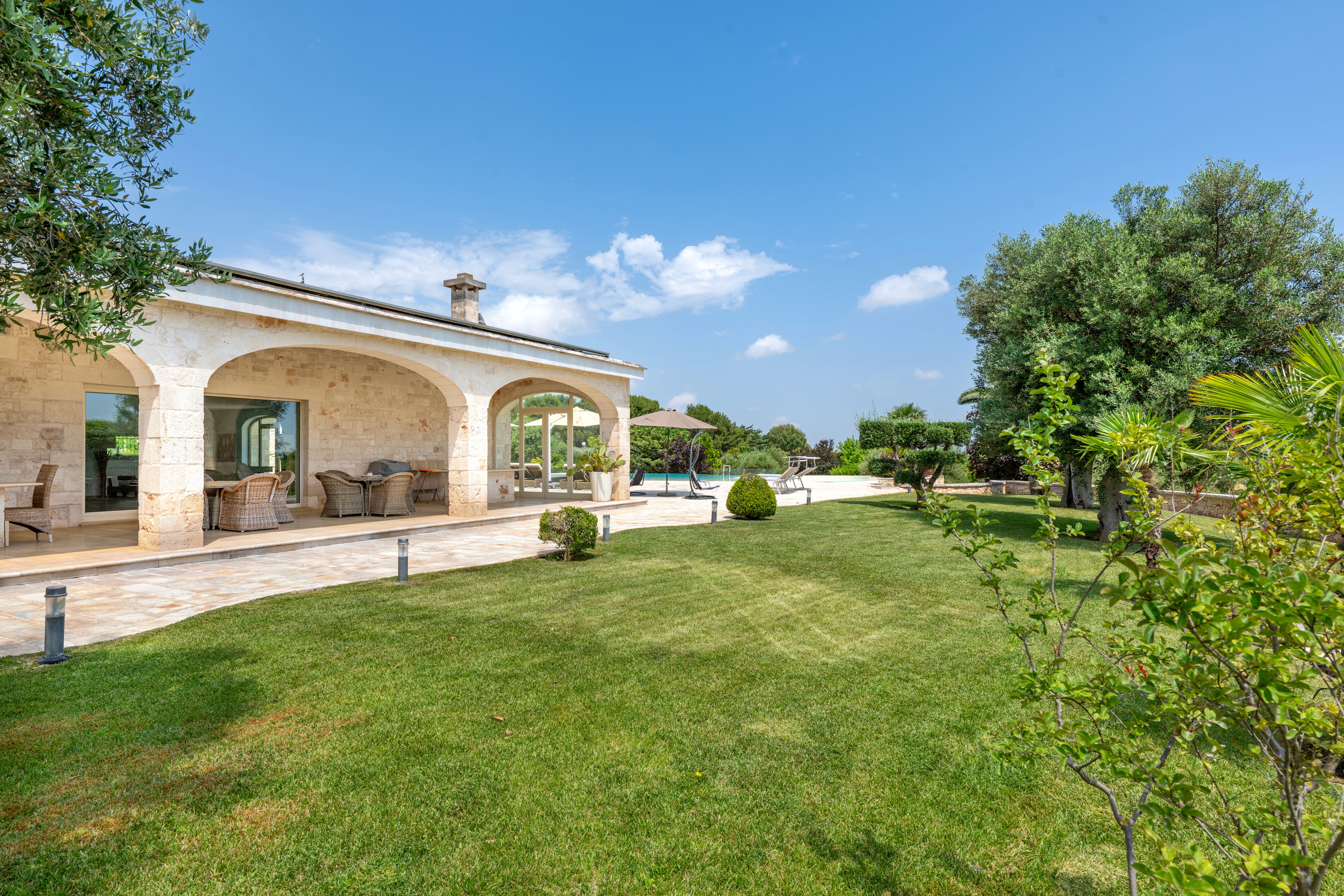 Modern hillside home with terracotta urn and mountain view