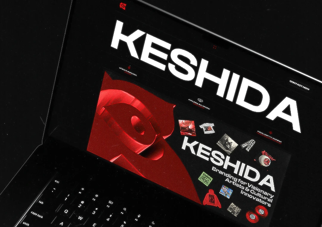 KESHIDA branding logo displayed on a laptop screen with a red and white color scheme. Branding for visionary artists and cultural innovators.