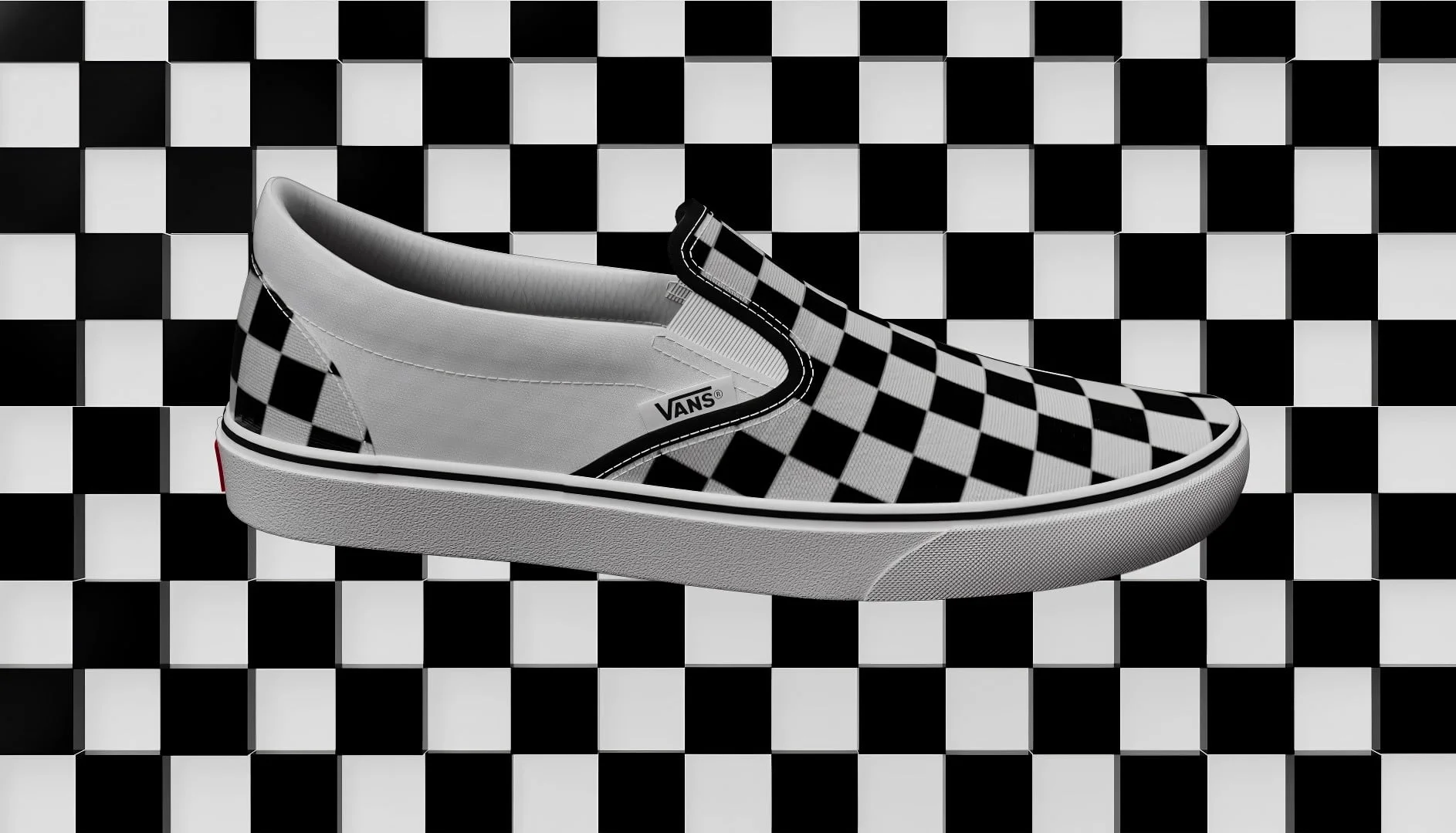 Black-and-white checkerboard Vans slip-on shoe on a checkerboard background, from the Vans Black Friday campaign