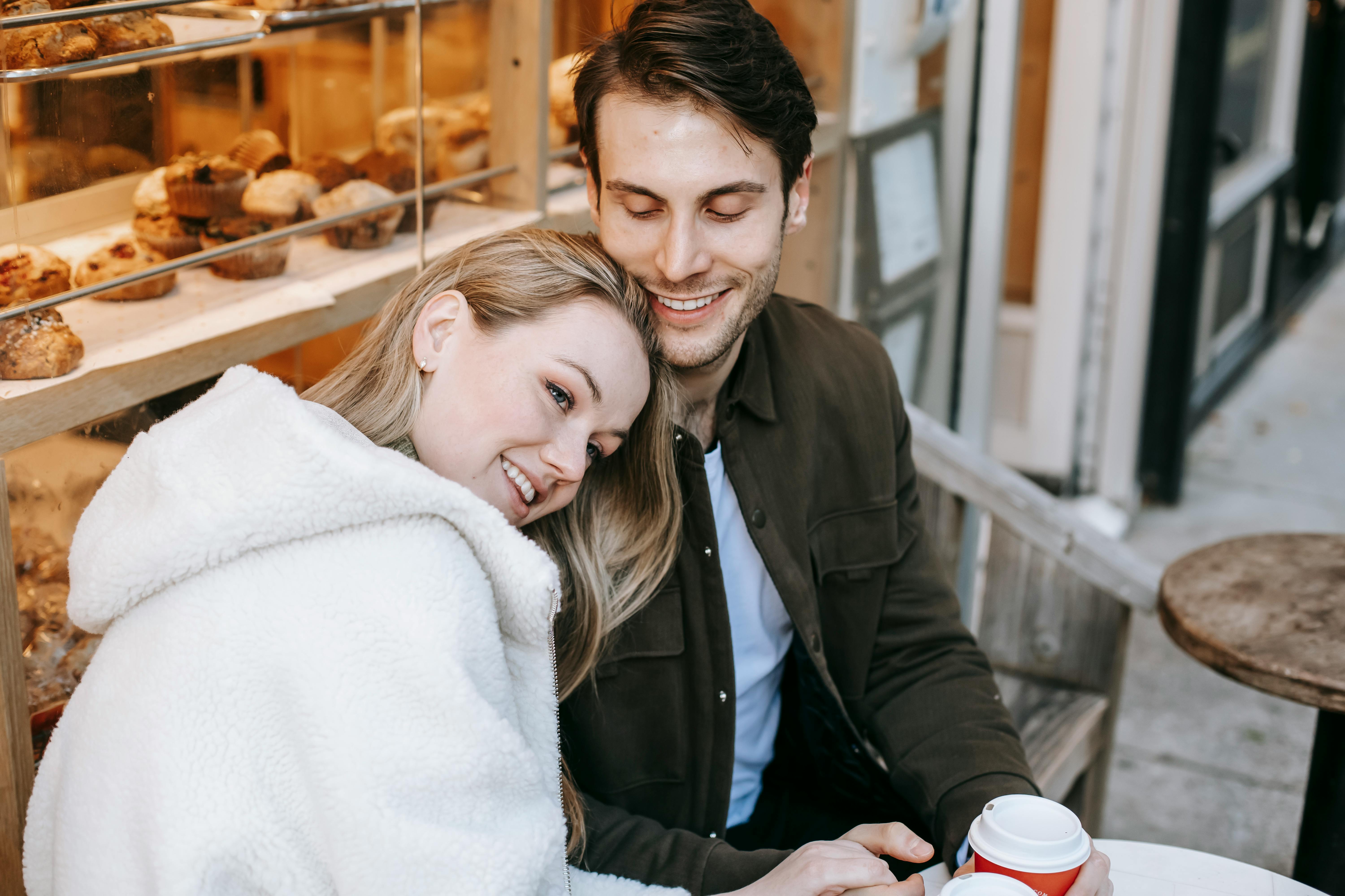 Couple sitting at a coffee table, smiling