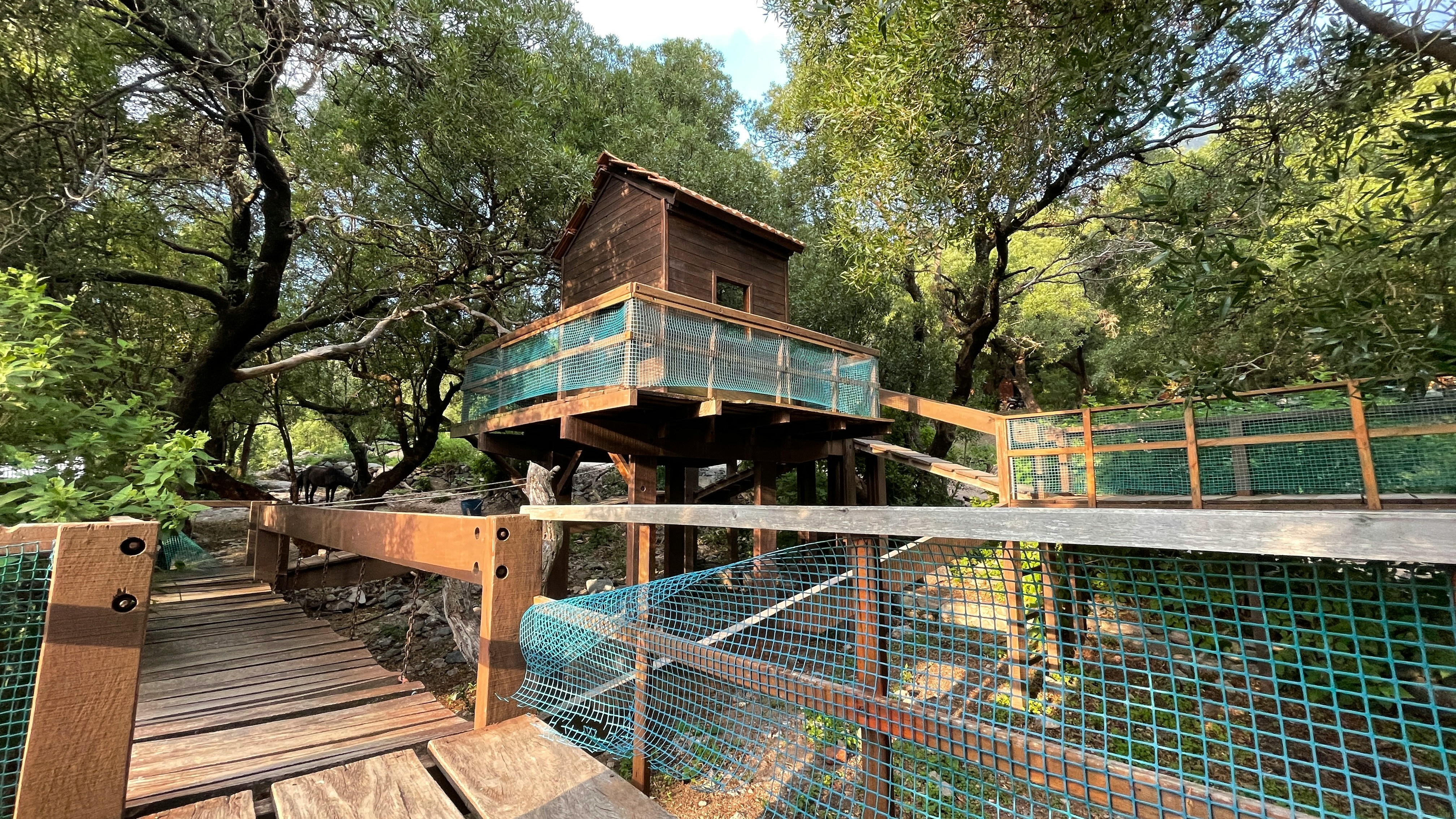 a tree house built on top of a wooden platform