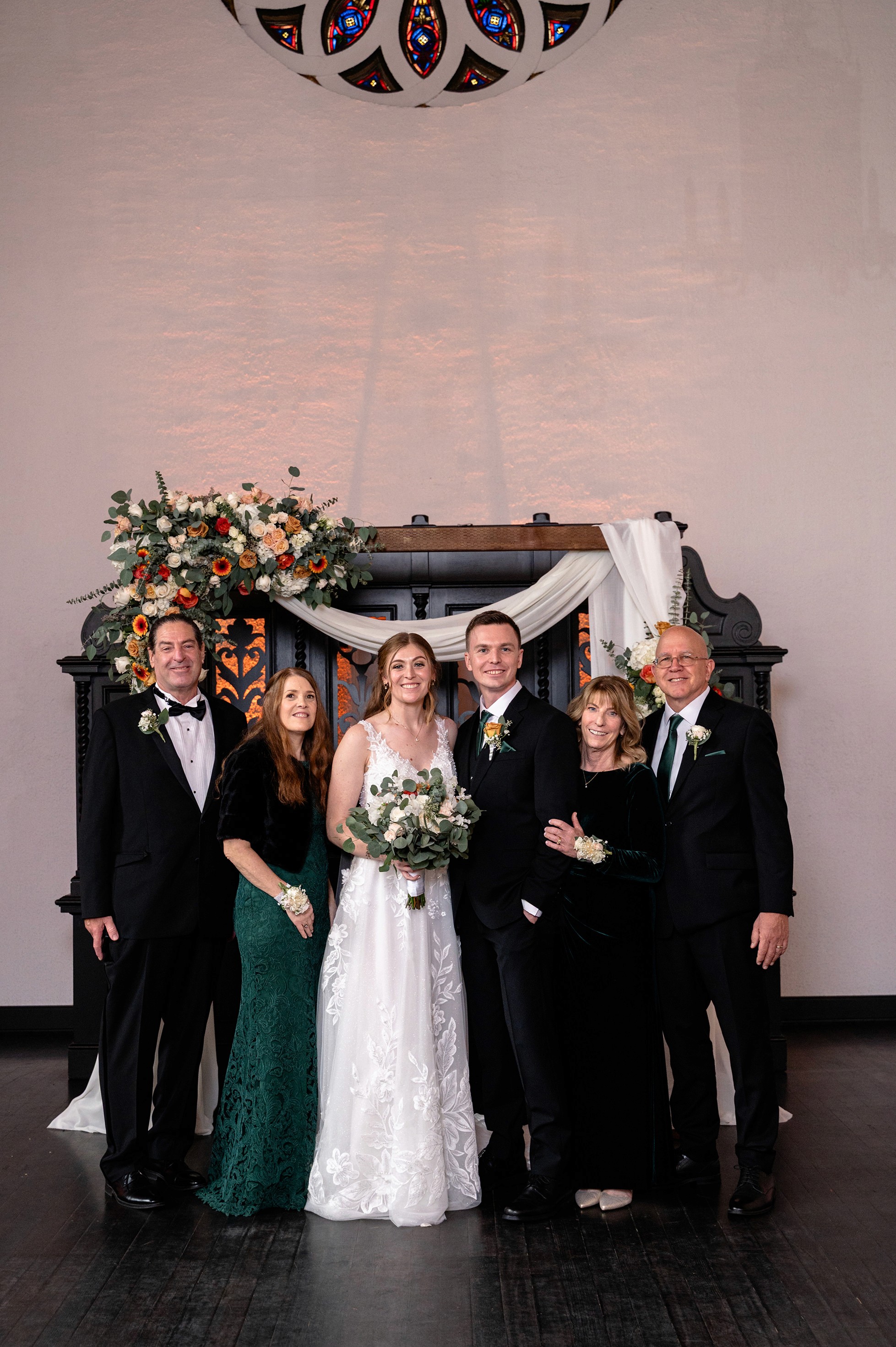 Flat lay wedding details with bouquet, rings, and sparkling bridal heels