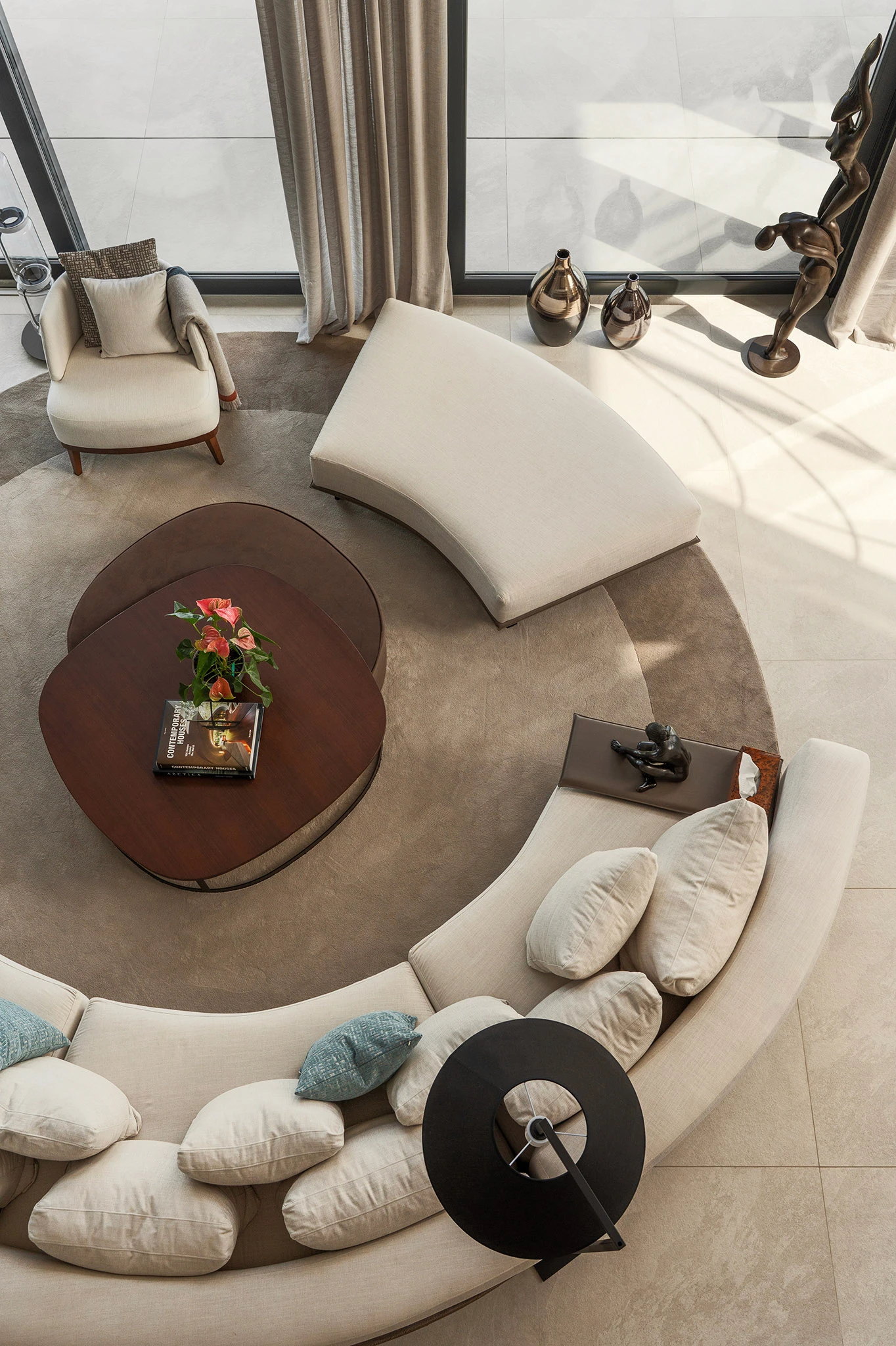Villa Vista Marbella lounge from above with curved sectional sofa, round coffee table, and circular rug