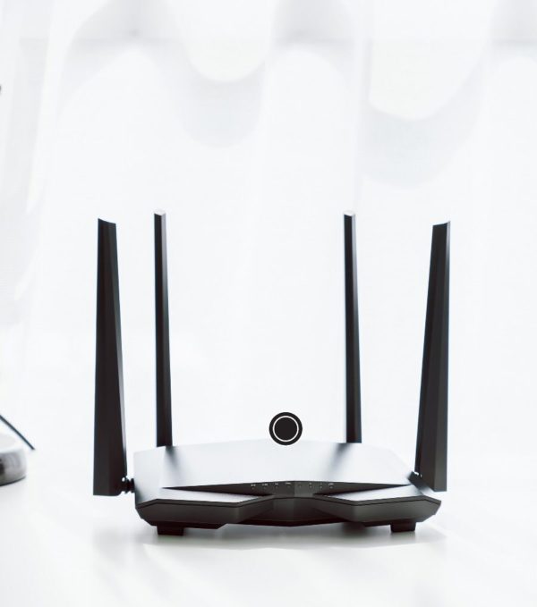 EMF remediation booster device with two antennas on a table