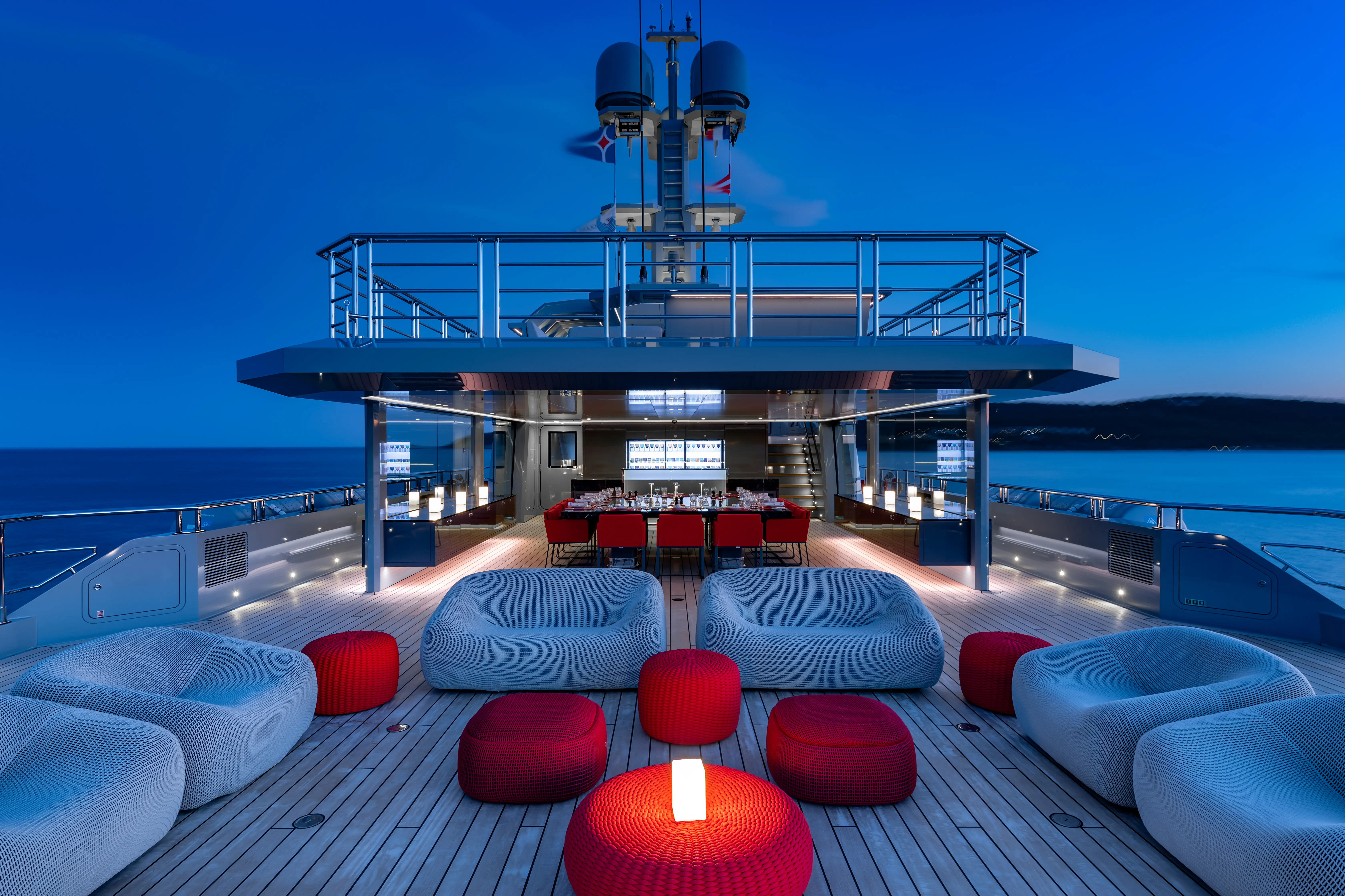 Modern symmetrical café interior with green booths, lights.
