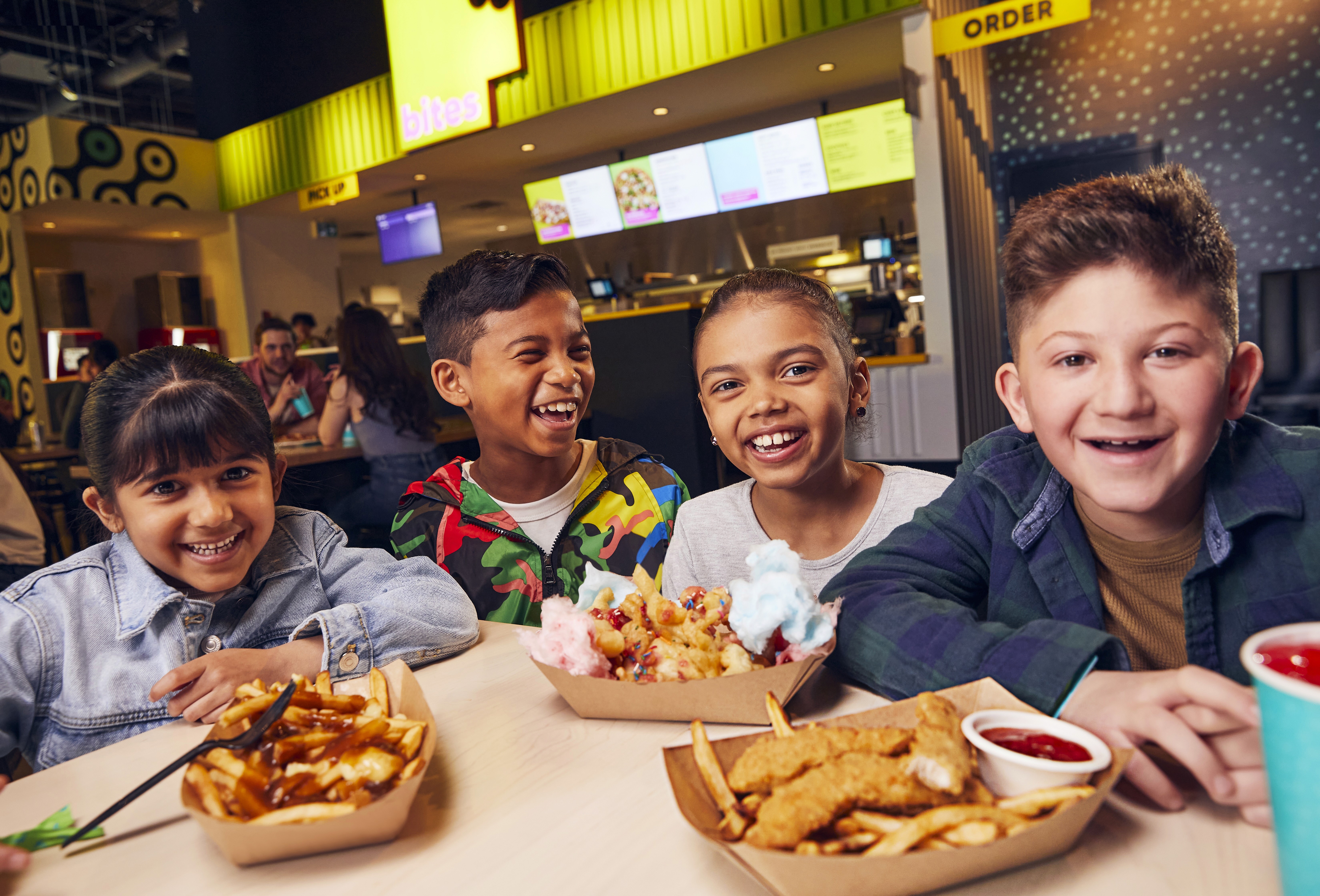 White branded cap with turquoise logo placed on fresh lemons in a red bowl
