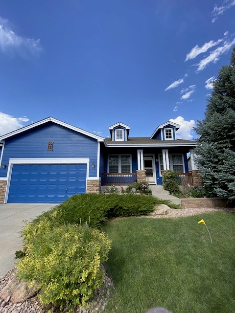 Completed exterior home painting project showing the refreshed blue siding and contrasting white trim.
