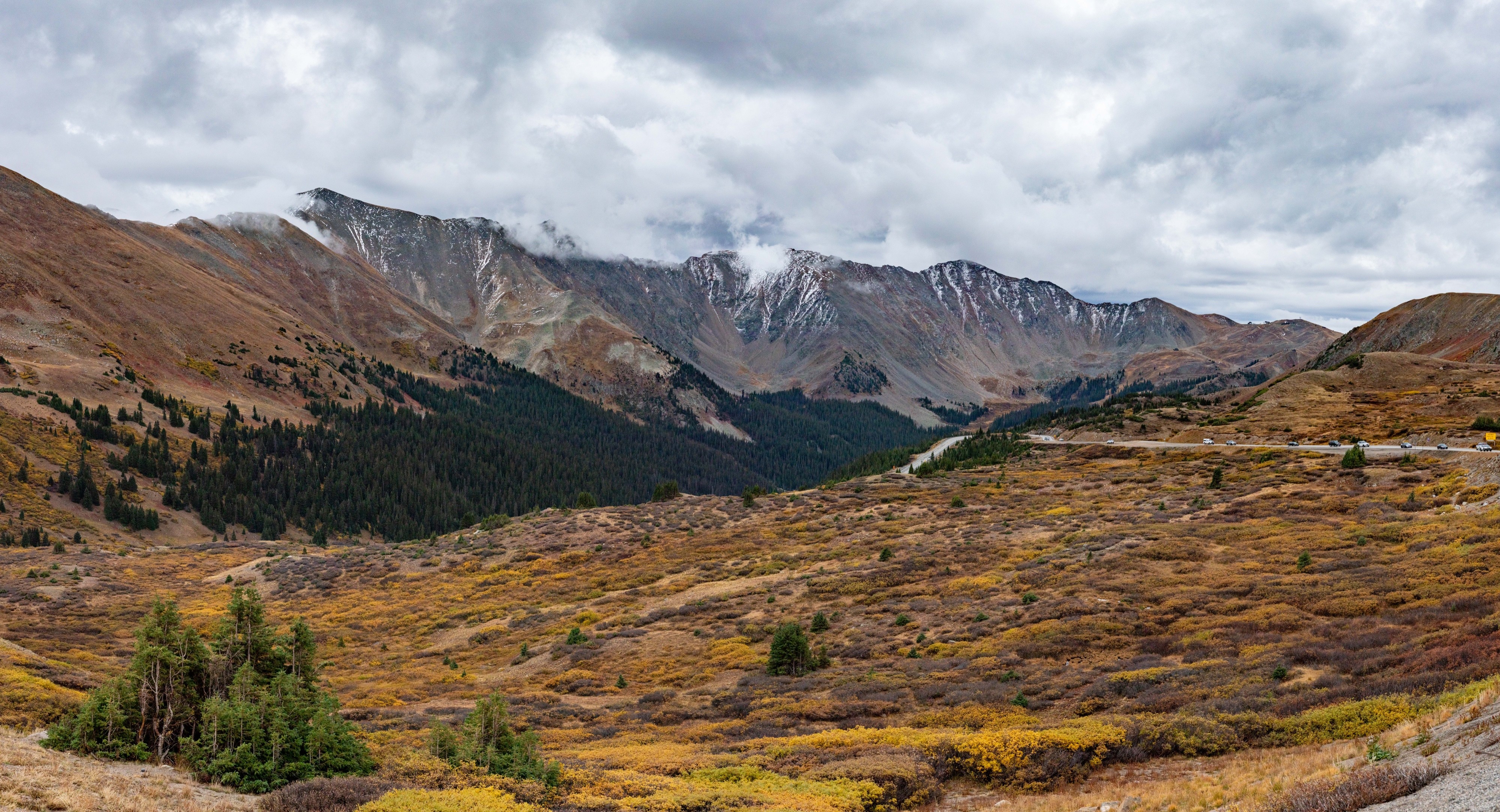 Panoramic landscape photograph of mountains, water, desert, or coast by Lucas Jensen