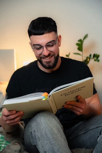 Designer Val reading a brand identity book, founder of Hival Design studio in Sofia