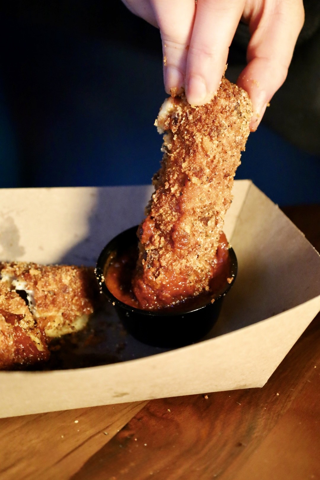 Completing a plate on a wood cutting board