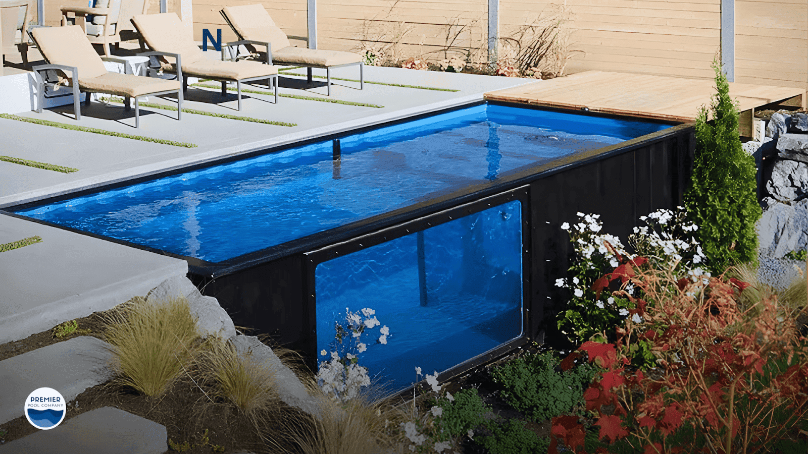 Modern shipping container pool with a wraparound deck installed in a compact Ohio backyard