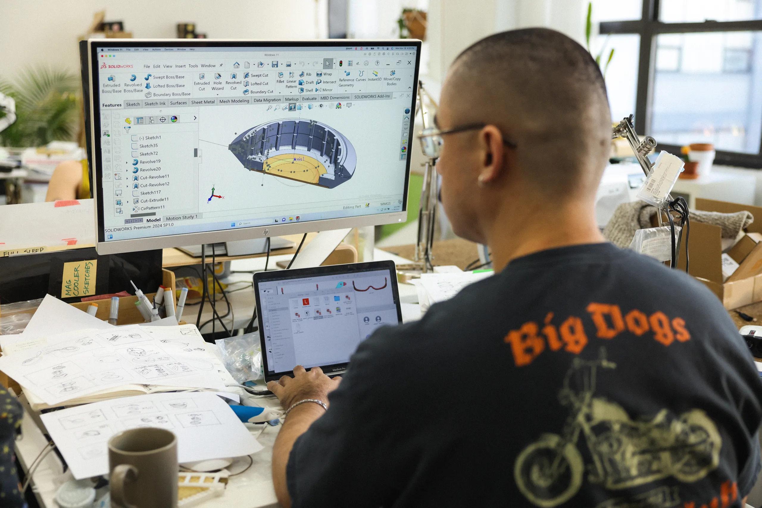 Engineer reviewing product CAD and manufacturing details at a workstation