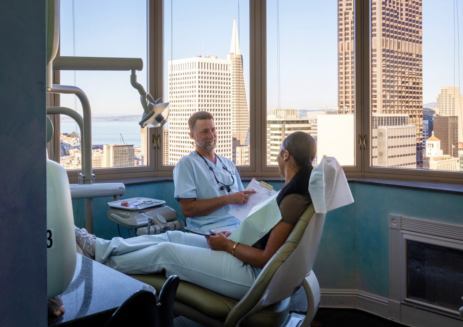 Dentist consulting with patient in dental office