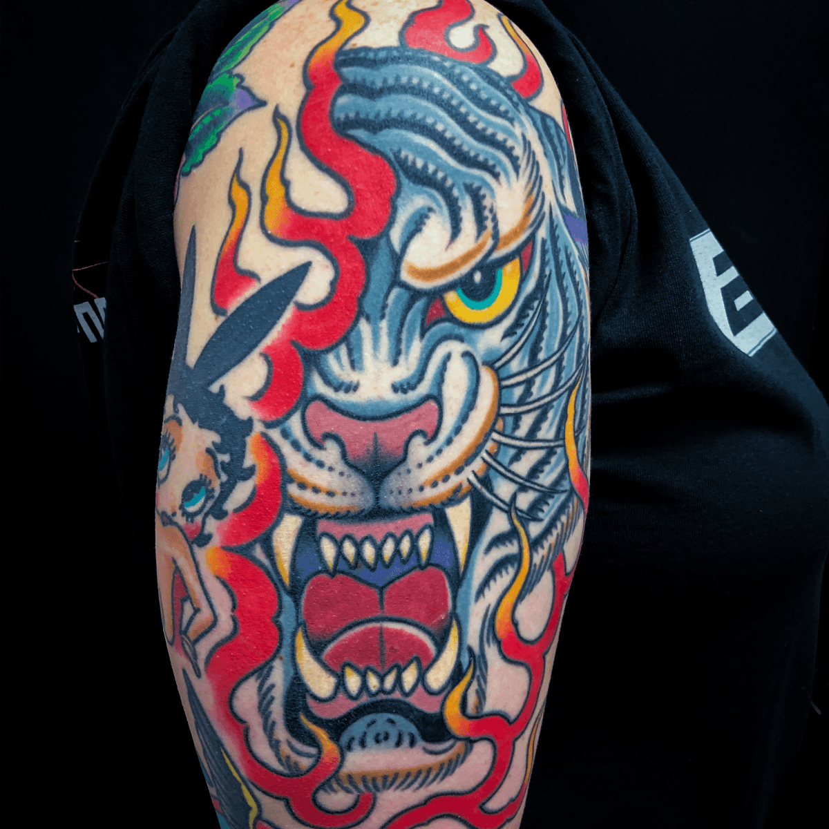 large color tattoo of a tiger head with flames