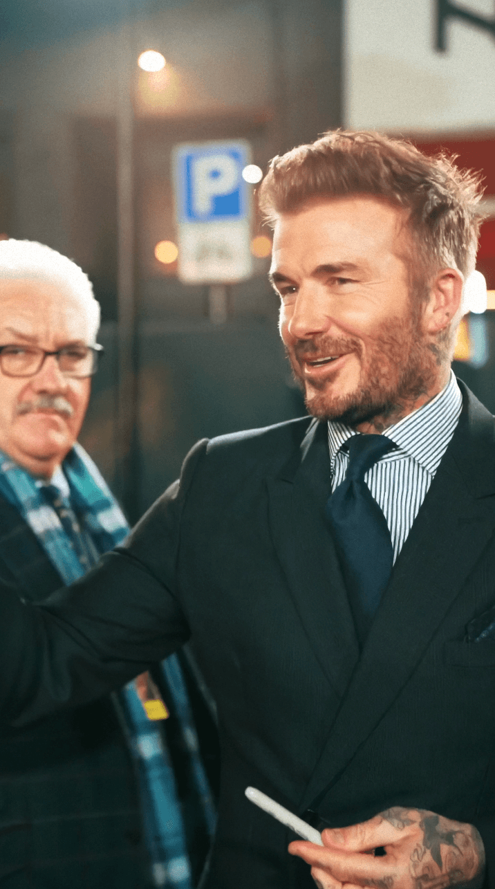 Woman in black outfit sitting on bar stool, leg extended