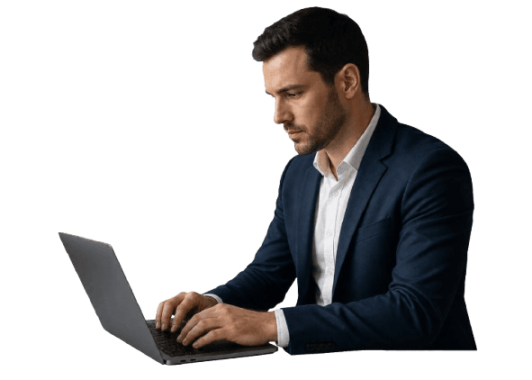 Man in suit working on laptop with coffee.