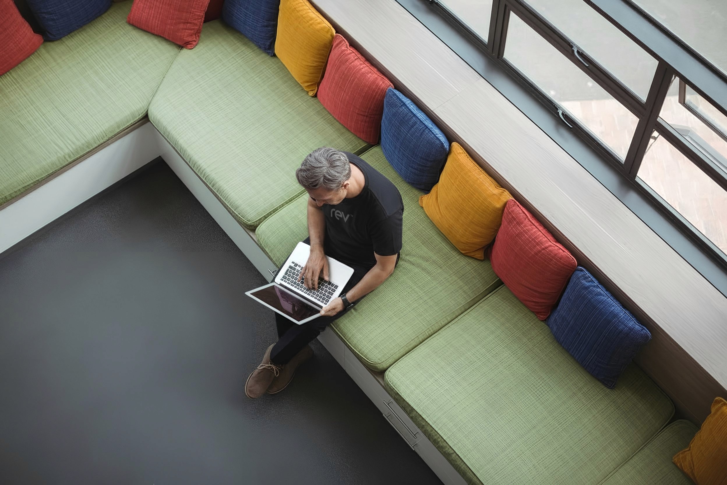 Colorful creative workspace with a desktop computer surrounded by vibrant retro-style posters and artwork on the wall