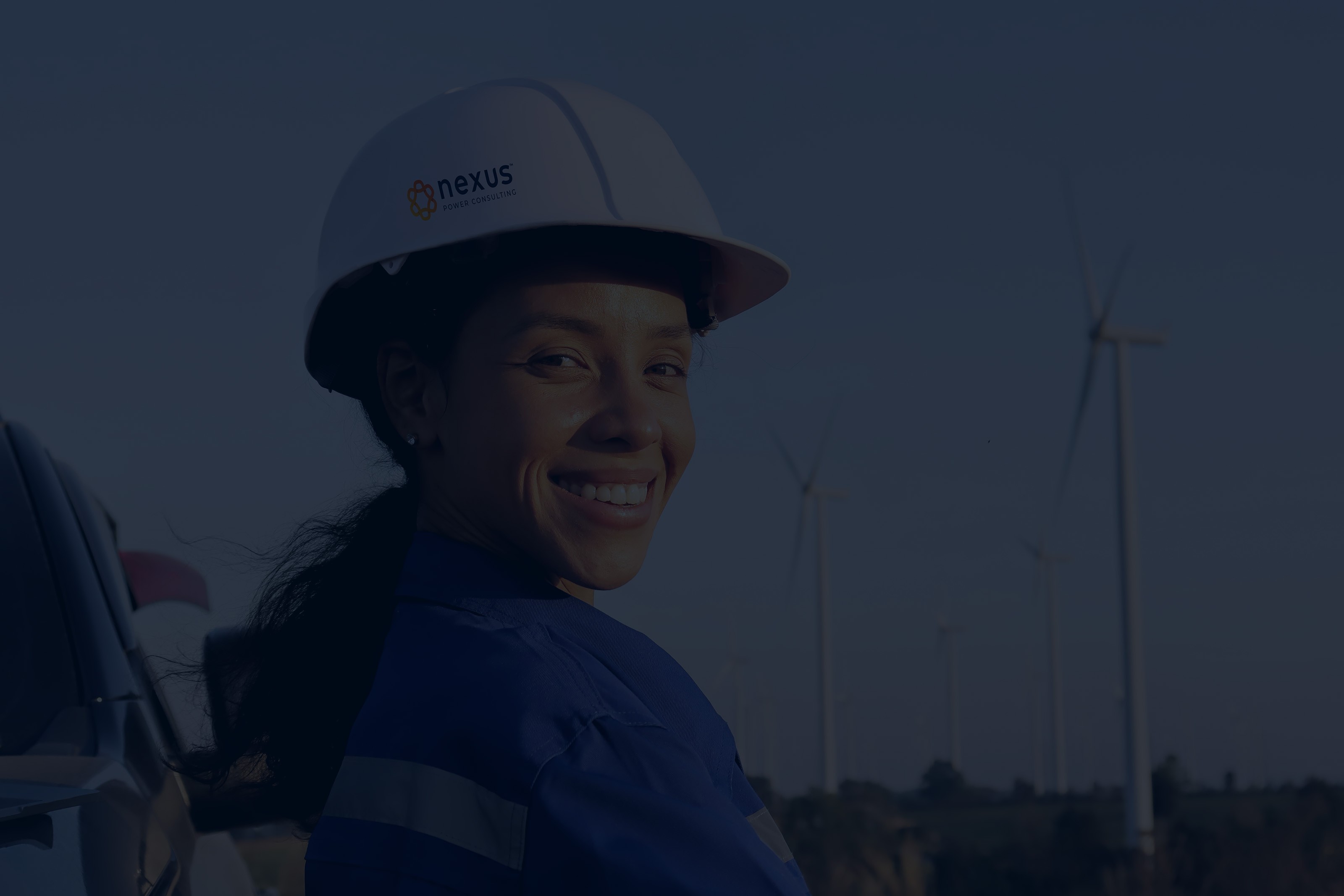 Smiling woman in hardhat.